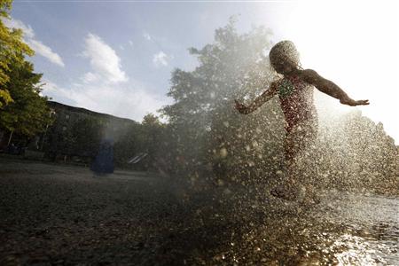 A girl cools off in the water from a playground sprinkler in the Brooklyn borough of New York July 15, 2013. REUTERS-Brendan McDermid
A girl cools off in the water from a playground sprinkler in the Brooklyn borough of New York July 15, 2013. REUTERS-Brendan McDermid