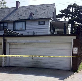 Police has taped off a house where they found another woman's body in a garage in East Cleveland, Ohio on July 21, 2013. Police in East Clev Police has taped off a house where they found another woman's body in a garage in East Cleveland, Ohio on July 21, 2013. Police in East Clev