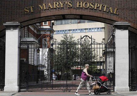 A woman pushes a baby pram past St Mary's Hospital, whose Lindo Wing is where Britain's Catherine, Duchess of Cambridge is expected to give A woman pushes a baby pram past St Mary's Hospital, whose Lindo Wing is where Britain's Catherine, Duchess of Cambridge is expected to give
