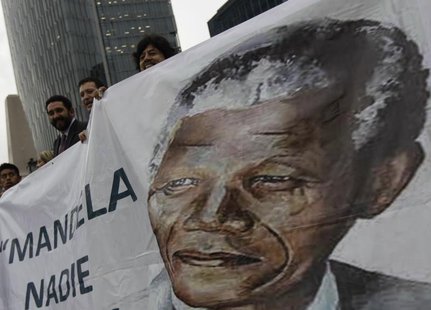 Well-wishers hold a giant banner with an image of former South African President Nelson Mandela during a celebration to mark Mandela's 95th Well-wishers hold a giant banner with an image of former South African President Nelson Mandela during a celebration to mark Mandela's 95th