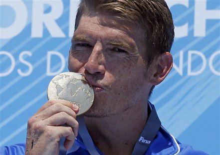 Winner Spyridon Gianniotis of Greece kisses his gold medal at the men's 10km open water victory ceremony during the World Swimming Champions Winner Spyridon Gianniotis of Greece kisses his gold medal at the men's 10km open water victory ceremony during the World Swimming Champions