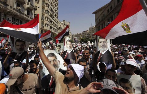 Members of the Muslim Brotherhood and supporters of ousted Egyptian President Mohamed Mursi shout slogans and close the roads during a prote Members of the Muslim Brotherhood and supporters of ousted Egyptian President Mohamed Mursi shout slogans and close the roads during a prote