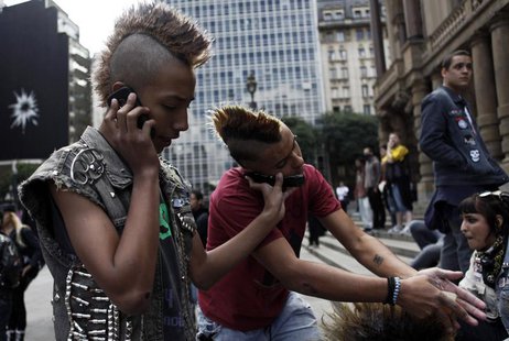 Brazilian punks use their mobile phones during a May Day demonstration on Labour Day in downtown Sao Paulo May 1, 2012. REUTERS/Nacho Doce Brazilian punks use their mobile phones during a May Day demonstration on Labour Day in downtown Sao Paulo May 1, 2012. REUTERS/Nacho Doce