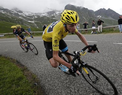 Race leader jersey holder Team Sky rider Christopher Froome of Britain cycles during the 204.5 km stage of the centenary Tour de France cycl Race leader jersey holder Team Sky rider Christopher Froome of Britain cycles during the 204.5 km stage of the centenary Tour de France cycl