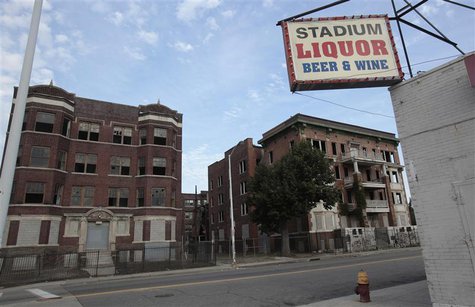 Two vacant and boarded up apartment buildings sit across from a liquor store near downtown Detroit, Michigan July 21, 2013. REUTERS/ Rebecca Two vacant and boarded up apartment buildings sit across from a liquor store near downtown Detroit, Michigan July 21, 2013. REUTERS/ Rebecca