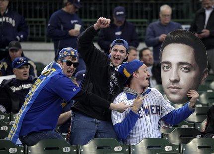 Fans hold up a giant photo of Milwaukee Brewers Ryan Braun before the start of opening day of baseball season as the Milwaukee Brewers take Fans hold up a giant photo of Milwaukee Brewers Ryan Braun before the start of opening day of baseball season as the Milwaukee Brewers take