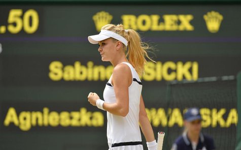 Agnieszka Radwanska of Poland reacts during her women's semi-final tennis match against Sabine Lisicki of Germany at the Wimbledon Tennis Ch Agnieszka Radwanska of Poland reacts during her women's semi-final tennis match against Sabine Lisicki of Germany at the Wimbledon Tennis Ch