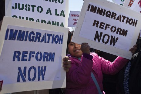 A girl holds up a banner while people take part in a rally to demand that Congress fix the broken immigration system at Liberty State Park i A girl holds up a banner while people take part in a rally to demand that Congress fix the broken immigration system at Liberty State Park i