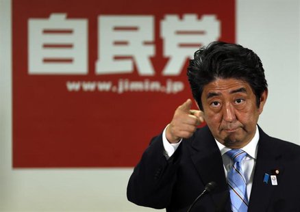 Japan's Prime Minister and the leader of the ruling Liberal Democratic Party (LDP), Shinzo Abe, points to a reporter during a news conferenc Japan's Prime Minister and the leader of the ruling Liberal Democratic Party (LDP), Shinzo Abe, points to a reporter during a news conferenc