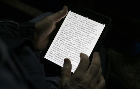 A man reads the bible from an iPad mini at the "Christ is the Answer International Ministries" group's camp near Florence February 2, 2013. A man reads the bible from an iPad mini at the "Christ is the Answer International Ministries" group's camp near Florence February 2, 2013.