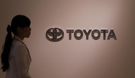 A woman walks past Toyota Motor's logo at the company showroom in Nagoya, central Japan July 1, 2013. REUTERS/Toru Hanai A woman walks past Toyota Motor's logo at the company showroom in Nagoya, central Japan July 1, 2013. REUTERS/Toru Hanai