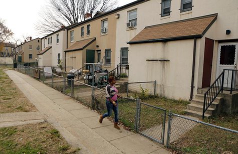 A woman walks on a path in the Berry Farm housing project in Ward 8 of Washington November 20, 2012. REUTERS/Kevin Lamarque A woman walks on a path in the Berry Farm housing project in Ward 8 of Washington November 20, 2012. REUTERS/Kevin Lamarque