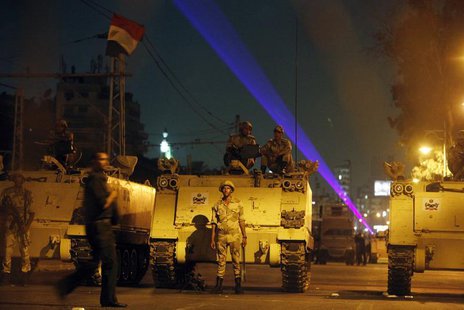 Egyptian Army soldiers stand guard on a road near the presidential palace in Cairo, July 19, 2013, as supporters of deposed president Mohame Egyptian Army soldiers stand guard on a road near the presidential palace in Cairo, July 19, 2013, as supporters of deposed president Mohame