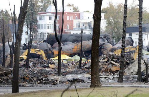 An emergency worker stands on the site of the train wreck in Lac Megantic, July 16, 2013. REUTERS/Ryan Remiorz/Pool An emergency worker stands on the site of the train wreck in Lac Megantic, July 16, 2013. REUTERS/Ryan Remiorz/Pool