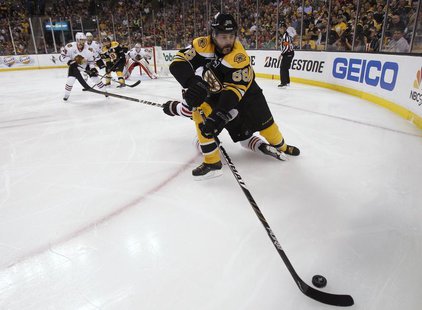 Boston Bruins right wing Jaromir Jagr (68) is checked along the boards by Chicago Blackhawks defenseman Duncan Keith (2) in the second perio Boston Bruins right wing Jaromir Jagr (68) is checked along the boards by Chicago Blackhawks defenseman Duncan Keith (2) in the second perio