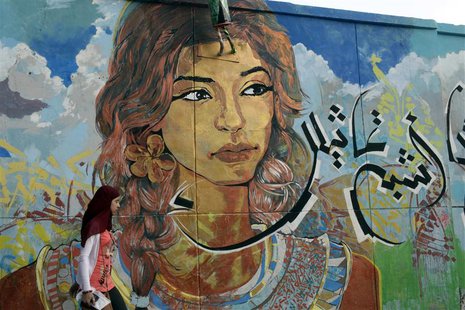 A girl walks past graffiti on a wall near Tahrir square in Cairo July 21, 2013. REUTERS/Asmaa Waguih A girl walks past graffiti on a wall near Tahrir square in Cairo July 21, 2013. REUTERS/Asmaa Waguih