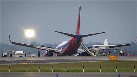 A Southwest Airlines Boeing 737 sits on the tarmac at LaGuardia airport, after making an emergency landing without its nose gear, in New York July 22, 2013.
REUTERS/Carlo Allegri A Southwest Airlines Boeing 737 sits on the tarmac at LaGuardia airport, after making an emergency landing without its nose gear, in New York July 22, 2013.
REUTERS/Carlo Allegri