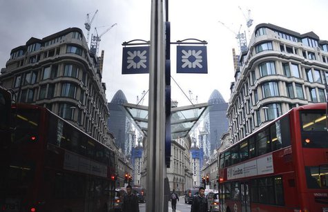 A logo from a Royal Bank of Scotland (RBS) branch is seen reflected in a window in the City of London March 6, 2013. REUTERS/Toby Melville A logo from a Royal Bank of Scotland (RBS) branch is seen reflected in a window in the City of London March 6, 2013. REUTERS/Toby Melville