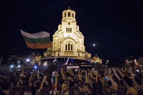 Protesters opposing the Socialist-led government throw plastic bottles and other objects at a heavily guarded bus trying to get deputies out Protesters opposing the Socialist-led government throw plastic bottles and other objects at a heavily guarded bus trying to get deputies out