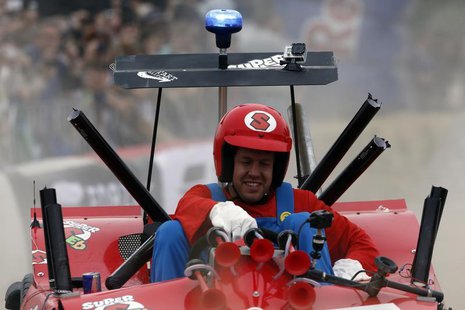 German three-time Red Bull Formula One world champion Sebastian Vettel reacts after crossing the finish line of a soapbox fun race in the we German three-time Red Bull Formula One world champion Sebastian Vettel reacts after crossing the finish line of a soapbox fun race in the we