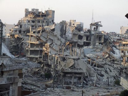 A general view shows damaged buildings on a deserted street in the besieged area of Homs July 13, 2013. REUTERS/Yazan Homsy A general view shows damaged buildings on a deserted street in the besieged area of Homs July 13, 2013. REUTERS/Yazan Homsy