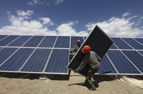 Workers install a solar panel in Jiuquan, Gansu province, July 14, 2013. REUTERS/Stringer Workers install a solar panel in Jiuquan, Gansu province, July 14, 2013. REUTERS/Stringer