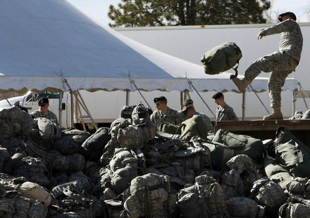 A U.S. Army soldier unloads the luggage of returning troops before a ceremony welcoming members of the U.S. Army returning from duty in Iraq A U.S. Army soldier unloads the luggage of returning troops before a ceremony welcoming members of the U.S. Army returning from duty in Iraq