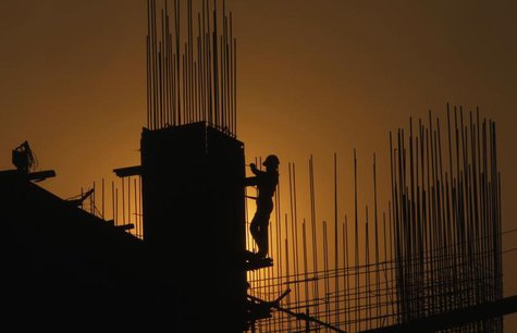 A worker arranges steel structures at a construction site of an apartment in Hanoi June 14, 2013. REUTERS/Kham A worker arranges steel structures at a construction site of an apartment in Hanoi June 14, 2013. REUTERS/Kham