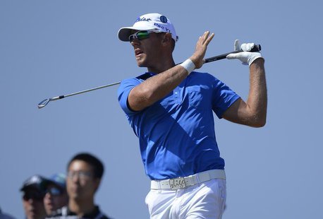 Graham Delaet of Canada watches his tee shot on the eighth hole during the third round of the British Open golf Championship at Muirfield in Graham Delaet of Canada watches his tee shot on the eighth hole during the third round of the British Open golf Championship at Muirfield in