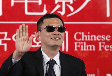 Director Wong Kar-wai waves during a news conference to promote his movie "The Grandmaster", the opening film of the Chinese Film Festival, Director Wong Kar-wai waves during a news conference to promote his movie "The Grandmaster", the opening film of the Chinese Film Festival,