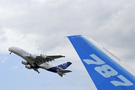 The vertical stabilizer of a Boeing 787 Dreamliner is seen as an Airbus A380, the world's largest jetliner, takes off during the 49th Paris The vertical stabilizer of a Boeing 787 Dreamliner is seen as an Airbus A380, the world's largest jetliner, takes off during the 49th Paris