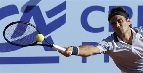 Switzerland's Roger Federer returns the ball to Germany's Daniel Brands during their Swiss Open second round tennis match in Gstaad July 25, Switzerland's Roger Federer returns the ball to Germany's Daniel Brands during their Swiss Open second round tennis match in Gstaad July 25,