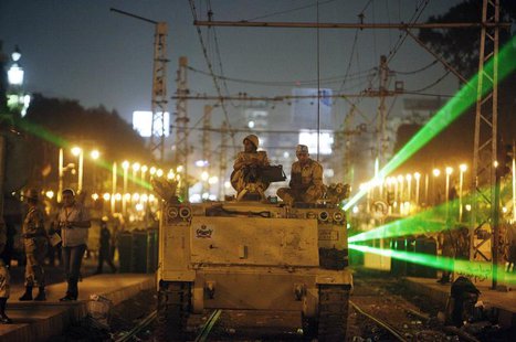 Egyptian Army soldiers sit on an armoured personnel carrier (APC) on a tram track, during a patrol, as supporters of deposed president Moham Egyptian Army soldiers sit on an armoured personnel carrier (APC) on a tram track, during a patrol, as supporters of deposed president Moham