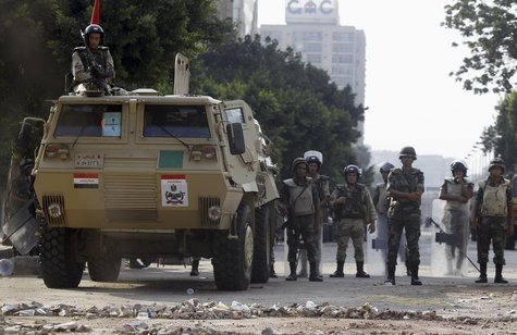 Army soldiers take positions in front of members of the Muslim Brotherhood and supporters of deposed Egyptian President Mohamed Mursi at Rep Army soldiers take positions in front of members of the Muslim Brotherhood and supporters of deposed Egyptian President Mohamed Mursi at Rep