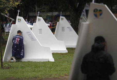 A man with the Australian flag confesses at the confessional booths set up at Quinta da Boa Vista park at the World Youth Day in Rio de Jane A man with the Australian flag confesses at the confessional booths set up at Quinta da Boa Vista park at the World Youth Day in Rio de Jane