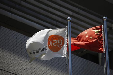 A flag (L) bearing the logo of GlaxoSmithKline (GSK) flutters next to a Chinese national flag outside a GlaxoSmithKline office building in S A flag (L) bearing the logo of GlaxoSmithKline (GSK) flutters next to a Chinese national flag outside a GlaxoSmithKline office building in S