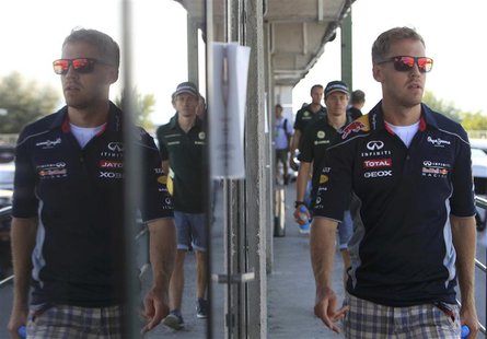 Red Bull Formula One driver Sebastian Vettel of Germany walks to the drivers' briefing after the second practice session of the Hungarian F1 Red Bull Formula One driver Sebastian Vettel of Germany walks to the drivers' briefing after the second practice session of the Hungarian F1