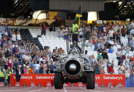 Jamaican sprinter Usain Bolt waves as he is driven round the Olympic Stadium in a rocket shaped vehicle at the London Diamond League 'Annive Jamaican sprinter Usain Bolt waves as he is driven round the Olympic Stadium in a rocket shaped vehicle at the London Diamond League 'Annive