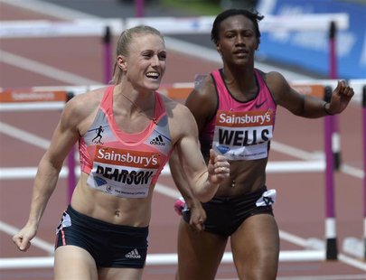 Sally Pearson (L) of Australia reacts next to third-placed Kellie Wells of the United States after winning the women's 100m hurdles at the L Sally Pearson (L) of Australia reacts next to third-placed Kellie Wells of the United States after winning the women's 100m hurdles at the L