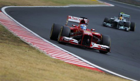 Ferrari Formula One driver Fernando Alonso of Spain drives ahead of Mercedes Formula One driver Lewis Hamilton (R) of Britain during the qua Ferrari Formula One driver Fernando Alonso of Spain drives ahead of Mercedes Formula One driver Lewis Hamilton (R) of Britain during the qua