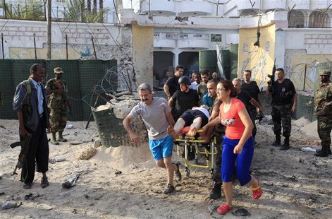 Turkish embassy staff carry their wounded colleague on a stretcher after a suicide car bomb attack at the gates of an office housing Turkish Turkish embassy staff carry their wounded colleague on a stretcher after a suicide car bomb attack at the gates of an office housing Turkish