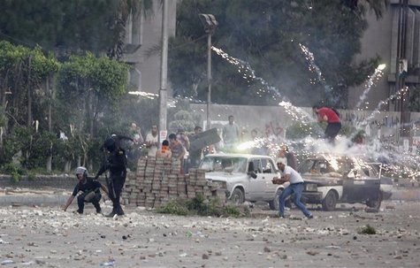 Fireworks are set off near police and anti-Mursi protesters by supporters of deposed Egyptian President Mohamed Mursi during clashes in Nasr Fireworks are set off near police and anti-Mursi protesters by supporters of deposed Egyptian President Mohamed Mursi during clashes in Nasr