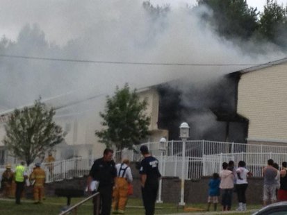Onlookers watch as firefighters battle a structure fire in the 700-block of Upham Road Friday afternoon Onlookers watch as firefighters battle a structure fire in the 700-block of Upham Road Friday afternoon