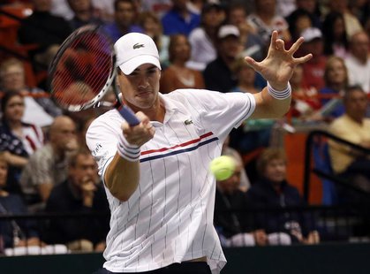 John Isner of the U.S. hits a return to Serbia's Novak Djokovic during their Davis Cup quarter-final tennis match in Boise, Idaho April 5, 2 John Isner of the U.S. hits a return to Serbia's Novak Djokovic during their Davis Cup quarter-final tennis match in Boise, Idaho April 5, 2