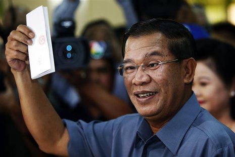 Cambodia's Prime Minister Hun Sen shows his ballot before casting it in the general elections at a polling station in Kandal province July 2 Cambodia's Prime Minister Hun Sen shows his ballot before casting it in the general elections at a polling station in Kandal province July 2