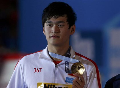 China's Sun Yang poses with his gold medal after winning the men's 400m freestyle final during the World Swimming Championships at the Sant China's Sun Yang poses with his gold medal after winning the men's 400m freestyle final during the World Swimming Championships at the Sant