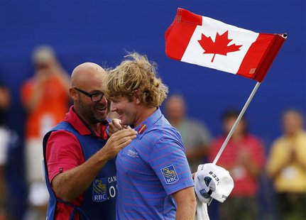 Brandt Snedeker of the U.S. celebrates with his caddy Scott Vail (L) of Canada after winning during the final round at the Canadian Open gol Brandt Snedeker of the U.S. celebrates with his caddy Scott Vail (L) of Canada after winning during the final round at the Canadian Open gol