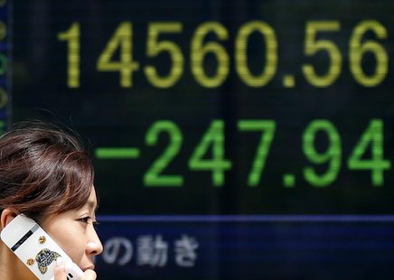 A woman walks past a stock quotation board displaying Japan's Nikkei average outside a brokerage in Tokyo July 19, 2013. REUTERS/Toru Hanai A woman walks past a stock quotation board displaying Japan's Nikkei average outside a brokerage in Tokyo July 19, 2013. REUTERS/Toru Hanai