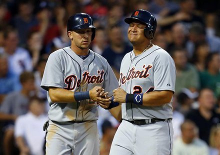 Detroit Tigers third baseman Miguel Cabrera (R) grimaces as he celebrates after scoring in the top of the fifth inning with teammate Hernan Detroit Tigers third baseman Miguel Cabrera (R) grimaces as he celebrates after scoring in the top of the fifth inning with teammate Hernan