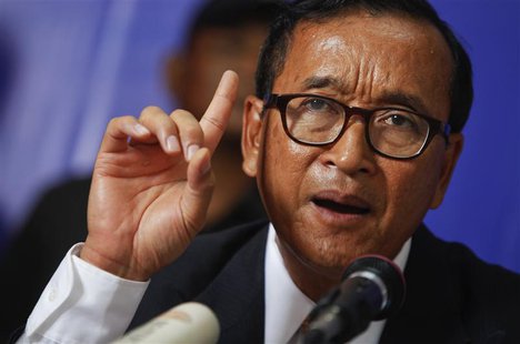 Sam Rainsy, president of the Cambodia National Rescue Party (CNRP) makes a point as he addresses reporters at his party's headquarters in Ph Sam Rainsy, president of the Cambodia National Rescue Party (CNRP) makes a point as he addresses reporters at his party's headquarters in Ph